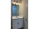 Bathroom featuring a well-lit vanity and mirror, with white cabinets and modern fixtures at 20296 Rutherford Ave, Port Charlotte, FL 33952