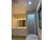 Bathroom features a double sink vanity, walk-in shower, and closet with shelving at 20296 Rutherford Ave, Port Charlotte, FL 33952