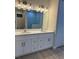 Double sink bathroom vanity with marble-look tile in walk-in shower at 20296 Rutherford Ave, Port Charlotte, FL 33952