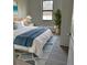 Stylishly decorated bedroom with natural light, coordinated rug, and a comfortable bed at 20296 Rutherford Ave, Port Charlotte, FL 33952