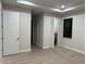 Bright bedroom features tray ceiling, modern doors, wood-look tile flooring, and natural light at 20296 Rutherford Ave, Port Charlotte, FL 33952