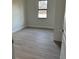 New bedroom with wood-look tile flooring and natural light at 20296 Rutherford Ave, Port Charlotte, FL 33952