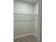 Walk-in closet features wood-look tile floors and wire shelving at 20296 Rutherford Ave, Port Charlotte, FL 33952
