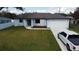 Charming single-story home with a well-manicured lawn, attached garage, and modern front door at 20296 Rutherford Ave, Port Charlotte, FL 33952