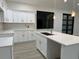 Bright kitchen with white cabinets, quartz countertops, and modern pendant lights above the island at 20296 Rutherford Ave, Port Charlotte, FL 33952