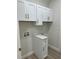Well-organized laundry area with white cabinets, a countertop, and washer/dryer hookups at 20296 Rutherford Ave, Port Charlotte, FL 33952