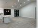 Spacious living room featuring vaulted ceilings, modern lighting, and wood-look tile flooring at 20296 Rutherford Ave, Port Charlotte, FL 33952