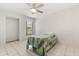 Light and airy bedroom with tiled floors, ceiling fan, and natural light from a window at 5744 Calais N Blvd # 4, St Petersburg, FL 33714