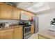 Efficient kitchen featuring light wood cabinets, stainless steel appliances, and a skylight at 5744 Calais N Blvd # 4, St Petersburg, FL 33714