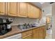 Functional kitchen with light wood cabinetry, stainless steel sink, and laminate countertops at 5744 Calais N Blvd # 4, St Petersburg, FL 33714