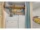 Laundry room features a full-size washer, dryer, and shelving, for convenient chores at 5744 Calais N Blvd # 4, St Petersburg, FL 33714