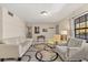 Cozy living room featuring neutral paint, tile flooring, large windows, and comfortable seating at 5744 Calais N Blvd # 4, St Petersburg, FL 33714