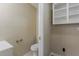 Small half bathroom with toilet, vanity and storage cabinets at 4010 Emerson S Ave, St Petersburg, FL 33711