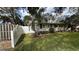 Side view of a charming home with a white picket fence and green shutters at 3141 Irving St, Sarasota, FL 34237