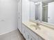 Bright bathroom offers a vanity with generous cabinet storage, a mirror, and tiled floors at 9420 Ripley Rd, Thonotosassa, FL 33592
