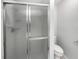 Bathroom features a glass enclosed shower with a white toilet and neutral walls at 9420 Ripley Rd, Thonotosassa, FL 33592
