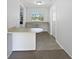 Eat-in kitchen with breakfast bar, ample storage, and neutral color palette at 9420 Ripley Rd, Thonotosassa, FL 33592