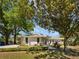 Charming single-story home with stone accents and lush landscaping creates great curb appeal at 9420 Ripley Rd, Thonotosassa, FL 33592