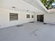 Covered back patio with concrete floor, white stucco, and recessed lights at 9420 Ripley Rd, Thonotosassa, FL 33592