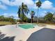 Beautiful pool with lush landscaping and mature palm trees in backyard at 9420 Ripley Rd, Thonotosassa, FL 33592