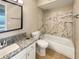 Bathroom featuring updated vanity with granite countertop and tub/shower combo with decorative tile surround at 9481 Highland Oak Dr # 609, Tampa, FL 33647