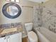 Bathroom featuring updated vanity with granite countertop and tub/shower combo with decorative tile surround at 9481 Highland Oak Dr # 609, Tampa, FL 33647