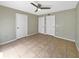 A neutral bedroom with tile floors, two closets, and a ceiling fan at 9481 Highland Oak Dr # 609, Tampa, FL 33647