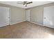 This neutral-toned bedroom offers tiled flooring, a ceiling fan, and convenient access to closet space at 9481 Highland Oak Dr # 609, Tampa, FL 33647