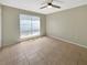 This spacious bedroom features tile floors and a bright window offering ample natural light at 9481 Highland Oak Dr # 609, Tampa, FL 33647