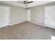 Spacious bedroom with tile floors, a ceiling fan, and neutral paint, providing a bright and airy feel at 9481 Highland Oak Dr # 609, Tampa, FL 33647