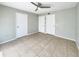 This large bedroom offers neutral tones, tiled flooring, and a ceiling fan for comfort at 9481 Highland Oak Dr # 609, Tampa, FL 33647