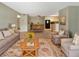 Open living room with tile floors, dining area, and kitchen in background at 9481 Highland Oak Dr # 609, Tampa, FL 33647
