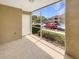 Screened patio with a view of the parking lot, a green hedge, and the neighboring building of the community at 9481 Highland Oak Dr # 609, Tampa, FL 33647
