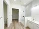Modern bathroom with a glass-enclosed shower, white vanity, and wood-look tile flooring at 15561 Aldama Cir, Port Charlotte, FL 33981