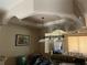 Dining area showcases decorative tray ceilings with a billiard light fixture overhead at 659 Eunice Dr, Tarpon Springs, FL 34689