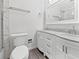 Bright bathroom featuring double vanity with white marble countertops and sleek white cabinetry at 837 Dolphin Nw Ave, Port Charlotte, FL 33948