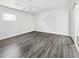 Bedroom with hardwood floors, white walls, modern ceiling fan and sliding glass door at 837 Dolphin Nw Ave, Port Charlotte, FL 33948