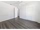 Well-lit bedroom with neutral colors, wood floors, and a spacious closet at 837 Dolphin Nw Ave, Port Charlotte, FL 33948