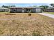 Charming single-story home with a well-maintained front yard, driveway, and attached garage at 837 Dolphin Nw Ave, Port Charlotte, FL 33948