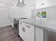Modern kitchen featuring white cabinets, stainless steel oven, and marble countertops at 837 Dolphin Nw Ave, Port Charlotte, FL 33948