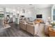 Open-concept living room showcasing modern design and seamless flow to kitchen with stainless steel appliances at 837 Dolphin Nw Ave, Port Charlotte, FL 33948