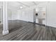 Spacious living room with hardwood floors, white walls, and decorative wood beams at 837 Dolphin Nw Ave, Port Charlotte, FL 33948