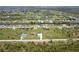 Expansive aerial view showcases a home's location amidst serene waterways and lush landscaping in a desirable community at 261 Rotonda S Blvd, Rotonda West, FL 33947