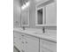 Bright bathroom with double sinks, white cabinets, and modern fixtures at 261 Rotonda S Blvd, Rotonda West, FL 33947