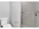 Tiled bathroom with modern toilet and tiled shower featuring a mosaic accent at 261 Rotonda S Blvd, Rotonda West, FL 33947