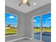 Bedroom with large windows and sliding glass doors overlooking the pool and backyard at 261 Rotonda S Blvd, Rotonda West, FL 33947