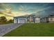Beautiful single-story home with a well-manicured lawn, double garage, and a neatly paved driveway at 261 Rotonda S Blvd, Rotonda West, FL 33947