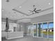 Open-concept living space with tray ceilings, pendant lights, and sliding glass doors at 261 Rotonda S Blvd, Rotonda West, FL 33947