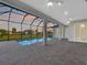 Inviting screened-in pool area with brick patio and serene sunset views at 261 Rotonda S Blvd, Rotonda West, FL 33947