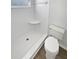 Bright bathroom featuring a stand-up shower with corner shelf and white tile at 8253 Penwood Dr, Port Richey, FL 34668